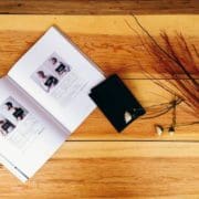 an open book sitting on top of a wooden table.