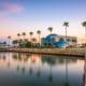 a large body of water surrounded by palm trees.