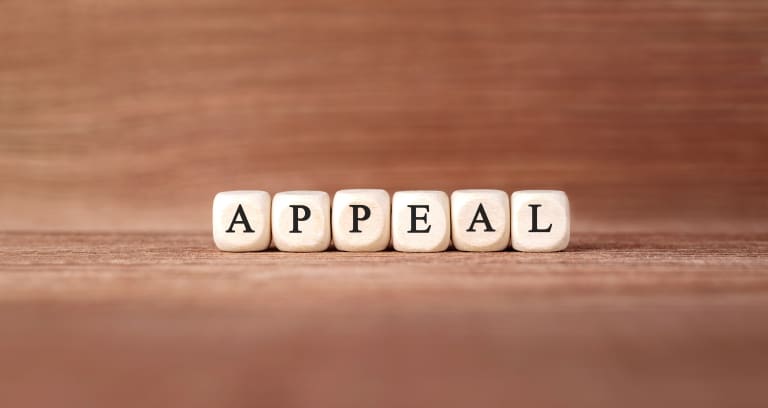 The word appeal spelled out on a wooden background.