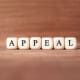 The word appeal spelled out on a wooden background.