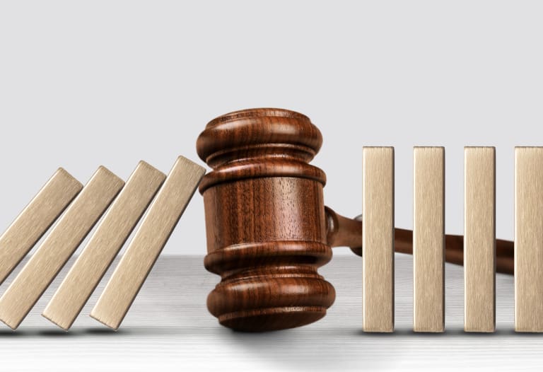 A wooden gavel with wooden blocks in front of it.