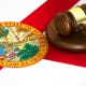 A gavel and the Florida state flag symbolizing the legal process of expungement in Florida.