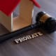 A gavel with the word probate next to a house.